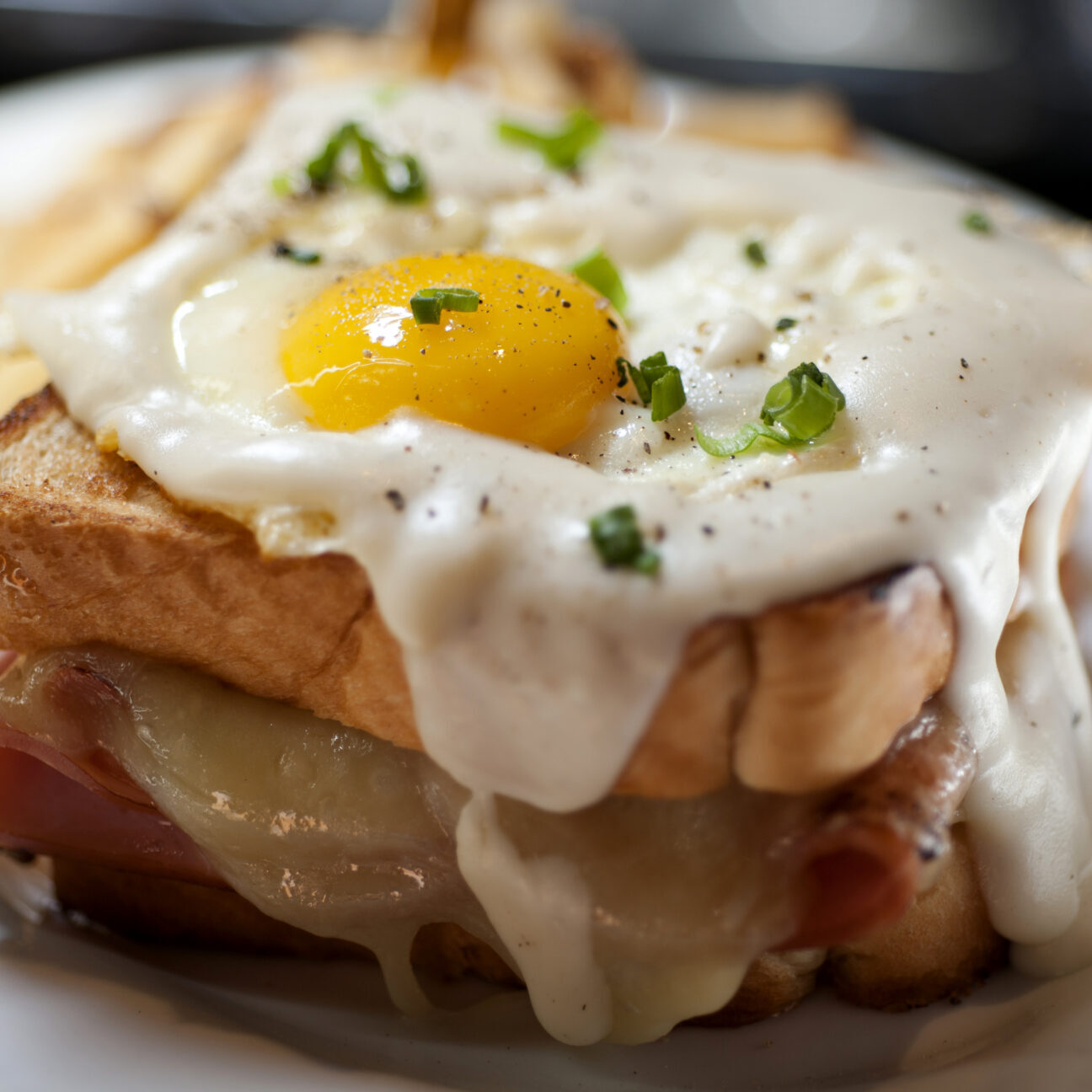 A Croque Madame on a white plate